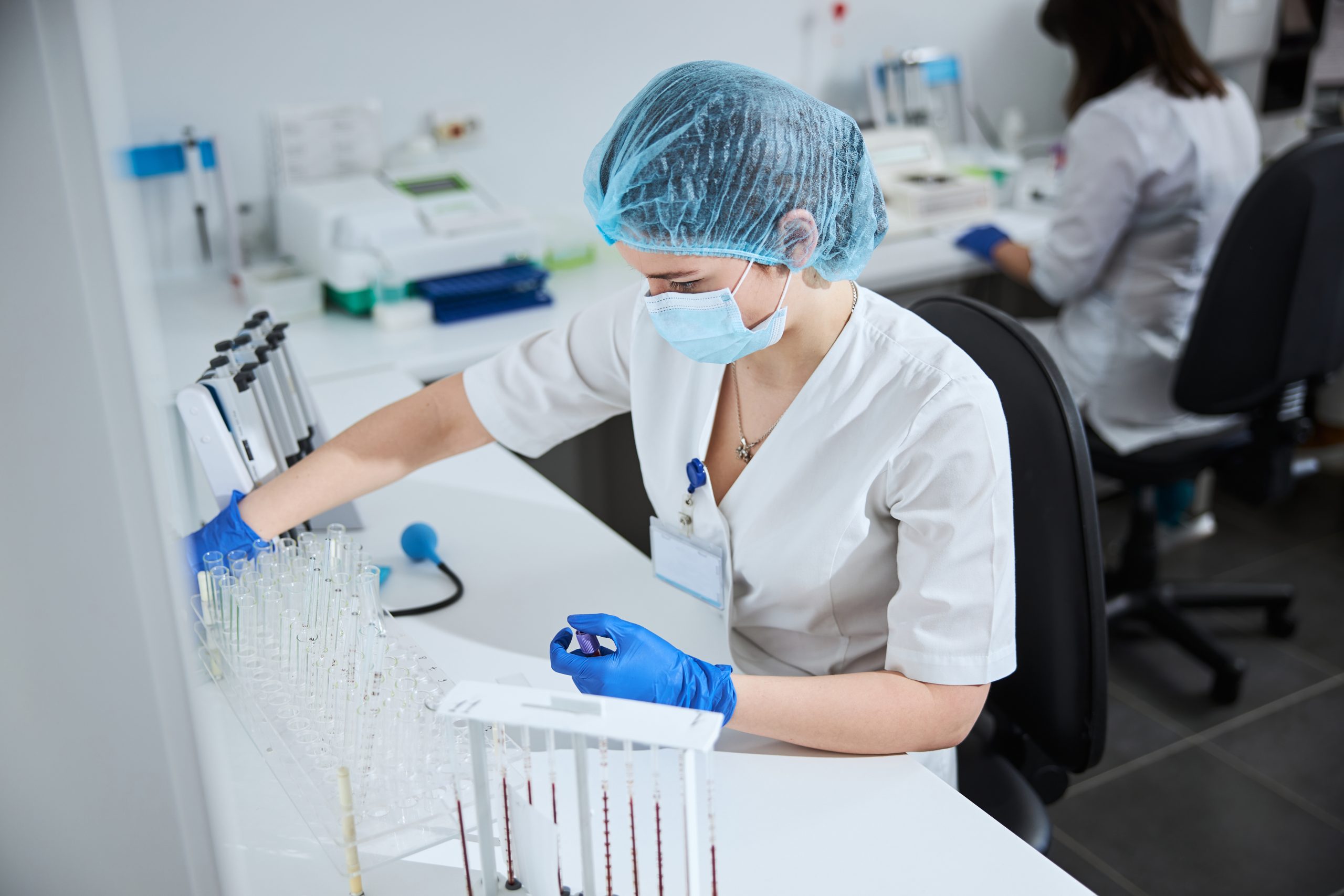 biochemist with a vacutainer sitting at a lab tabl 2023 11 27 05 04 56 utc scaled