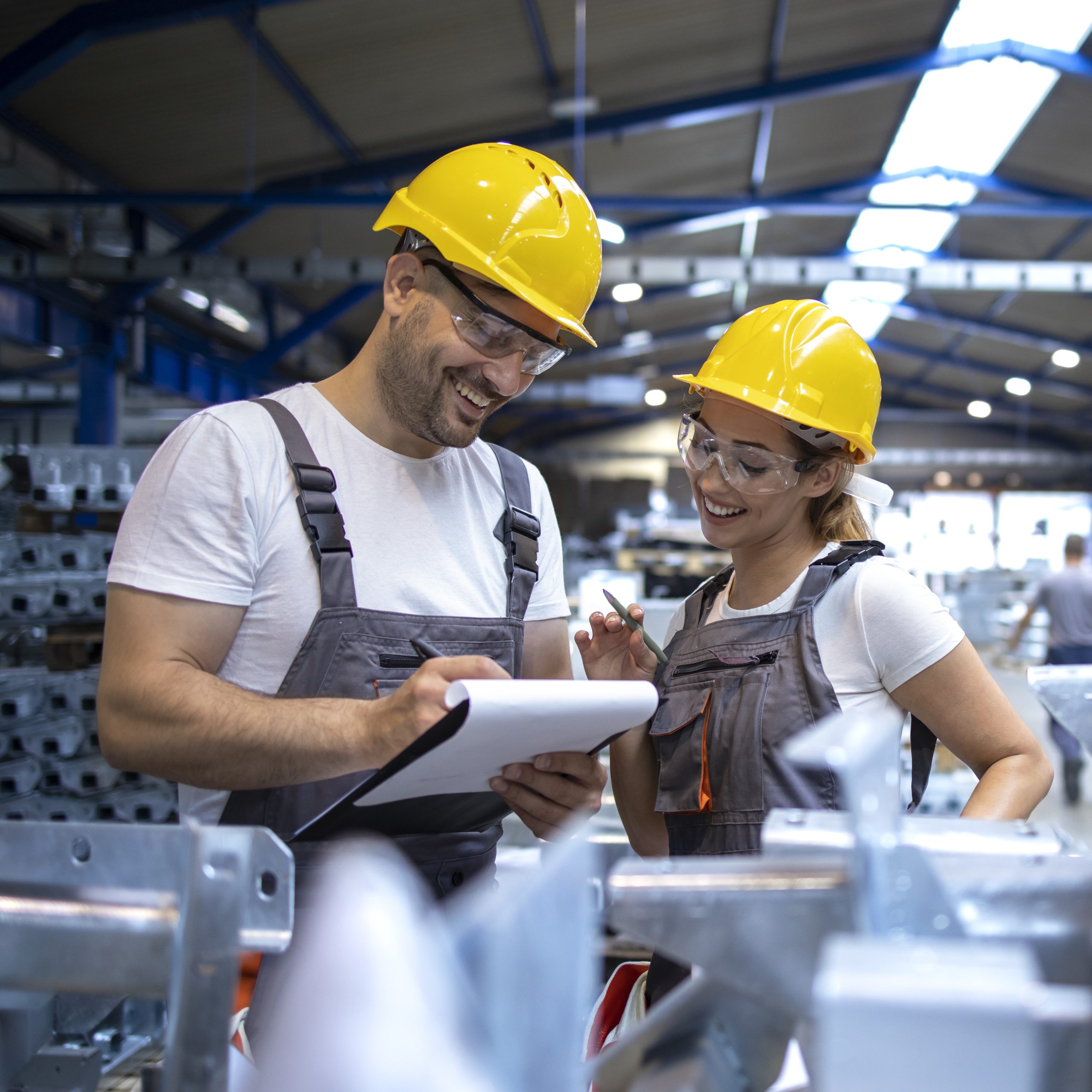 factory workers analyzing production results large industrial hall scaled